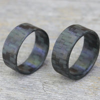 Ultralight Glowing Carbon Fiber Ring Compared To It's Thicker Variant Overhead View