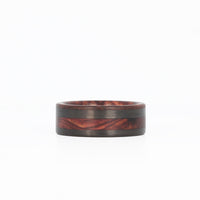 rosewood wedding ring with offset carbon fiber inlay laying flat