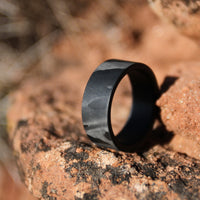 men's carbon fiber wedding ring on the red rocks of the desert