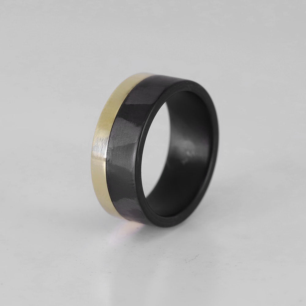 Men's carbon fiber ring with yellow gold band overhead view