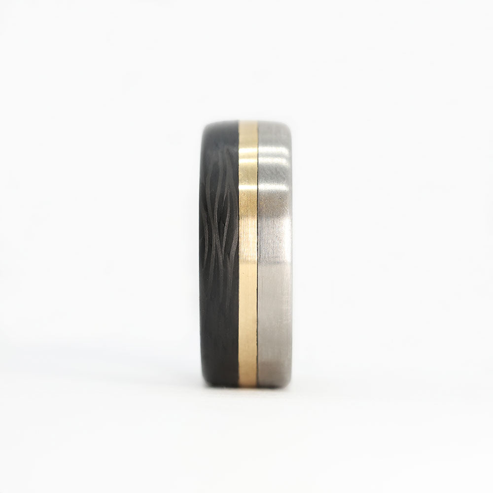 titanium ring with gold and carbon fiber inlays front view