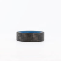 Blue Glowing Resin Ring with Carbon Fiber Exterior laying flat