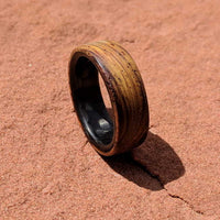 cocobolo ring with carbon fiber sleeve on red rocks