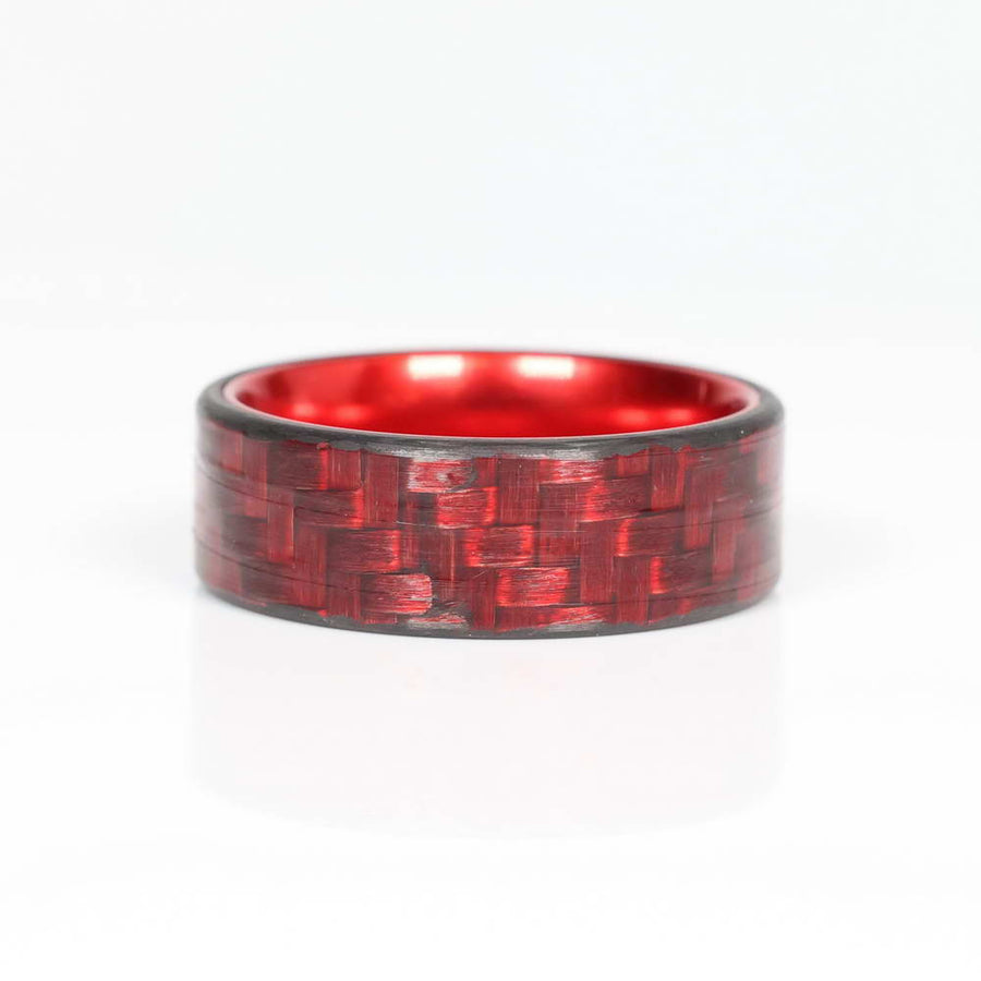 Red Carbon Fiber Men's Ring With Red Aluminum Interior Laying Flat