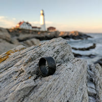 Carbon Fiber Glow Ring On Beach Background
