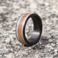 Deer antler wedding band with whiskey barrel wood and carbon fiber sleeveon marble