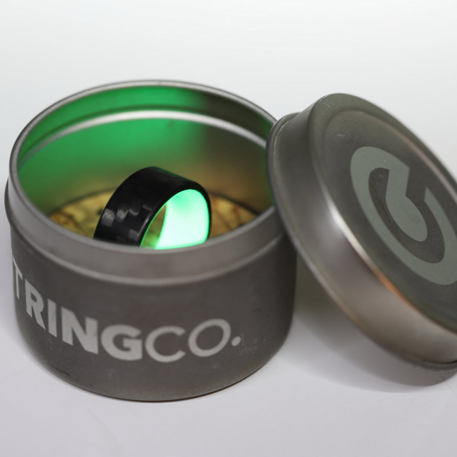 Carbon Fiber Green Glow Ring Glowing In Its Container