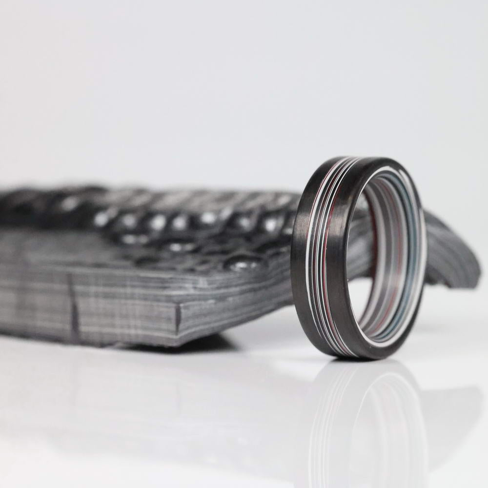 Fordite Men's Ring with Carbon Fiber Rails with a plate of Fordite