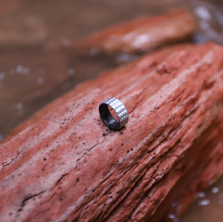 fiberglass ring with carbon fiber sleeve on a red rock