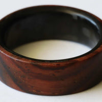cocobolo ring with carbon fiber laying flat close up