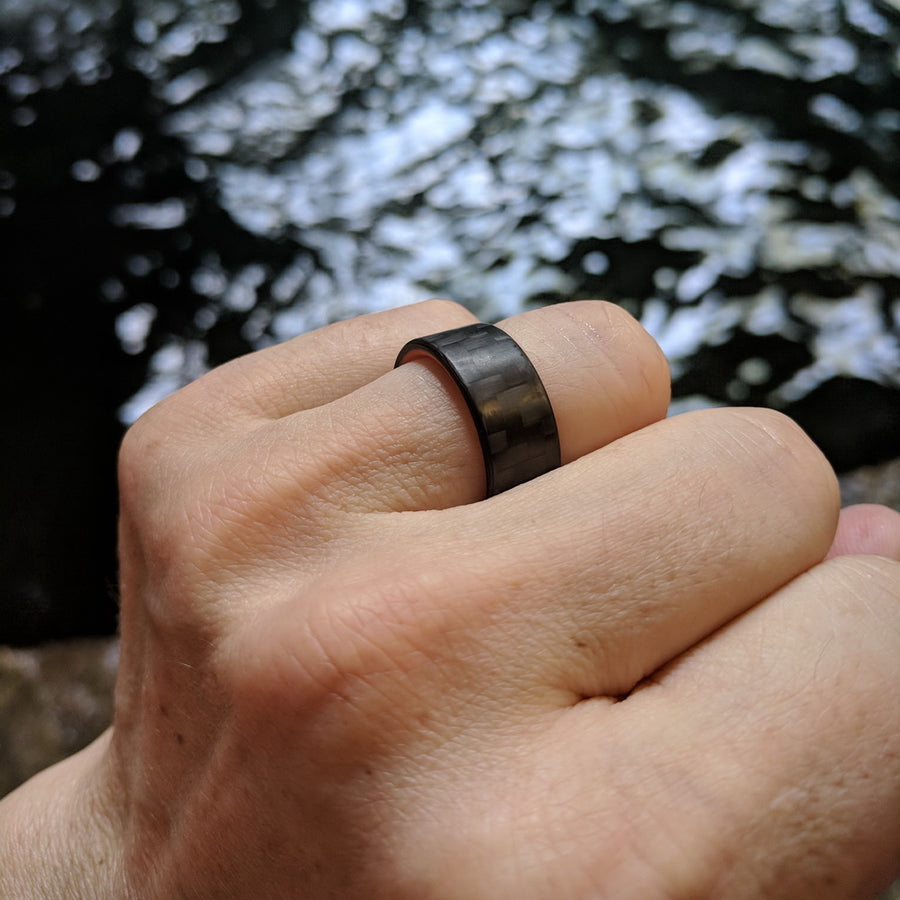 Orange Glow Ring with Carbon Fiber Worn on Finger