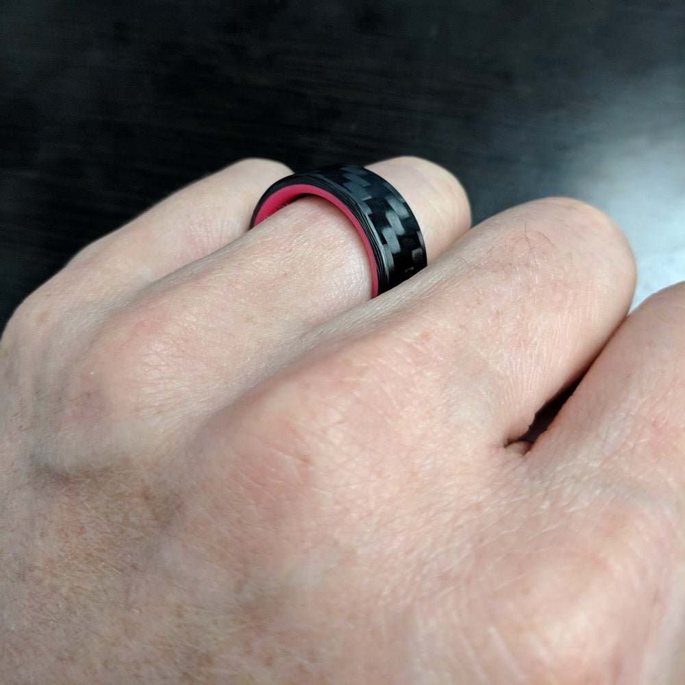 Red Glowing Ring with Carbon Fiber On A Finger