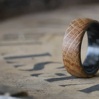 whiskey barrel ring with carbon fiber sleeve on a whiskey barrel lid