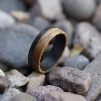 Men's whiskey barrel ring with carbon fiber in pebbles