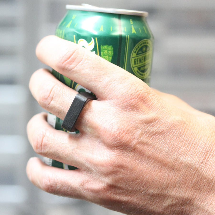 Square Carbon Fiber Wedding Ring On A Hand Holding A Beer