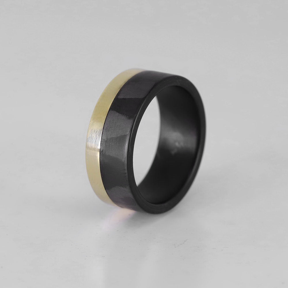 Men's carbon fiber ring with yellow gold band overhead view