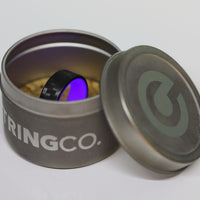 Purple Glow In The Dark Ring with Carbon Fiber glowing in its container