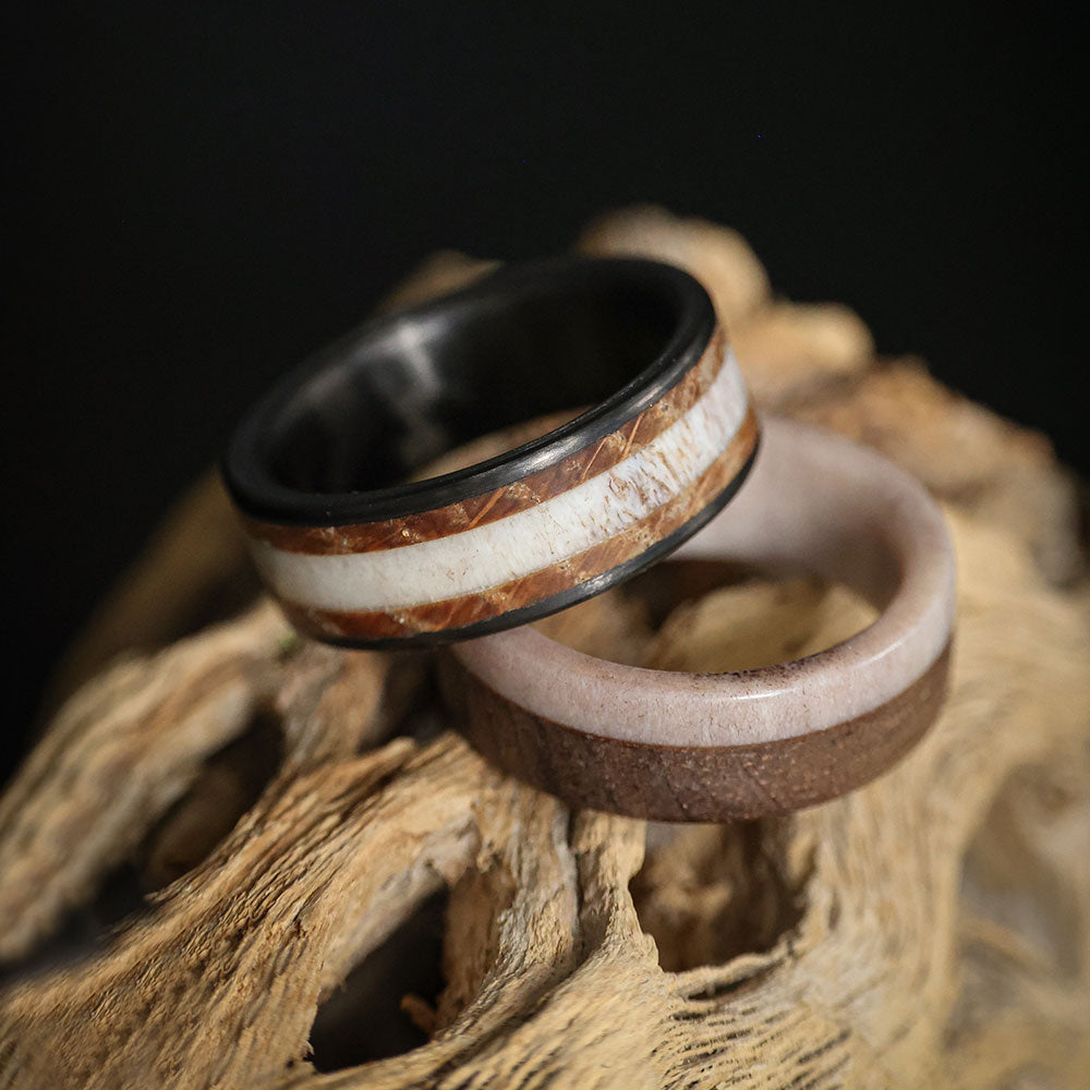 deer antler men's wedding band with whiskey barrel wood and carbon fiber on log