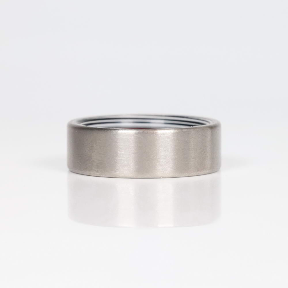 Fordite Wedding Ring with Titanium Exterior Laying Flat