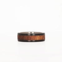 men's koa wood ring with carbon fiber rails and titanium sleeve laying down