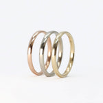 gold stackable rings set with rose gold, white gold, and yellow gold