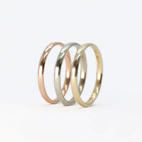 gold stackable rings set with rose gold, white gold, and yellow gold