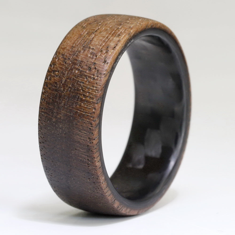 walnut wooden wedding ring with carbon fiber sleeve close up
