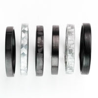 gray stackable ring made from glass fiber in a collection of other stackable rings